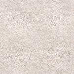 Close-up of light beige carpet fibers with a loop texture, seen from above.