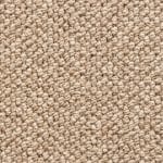 Close-up of beige looped carpet fibers forming a dense textured surface.