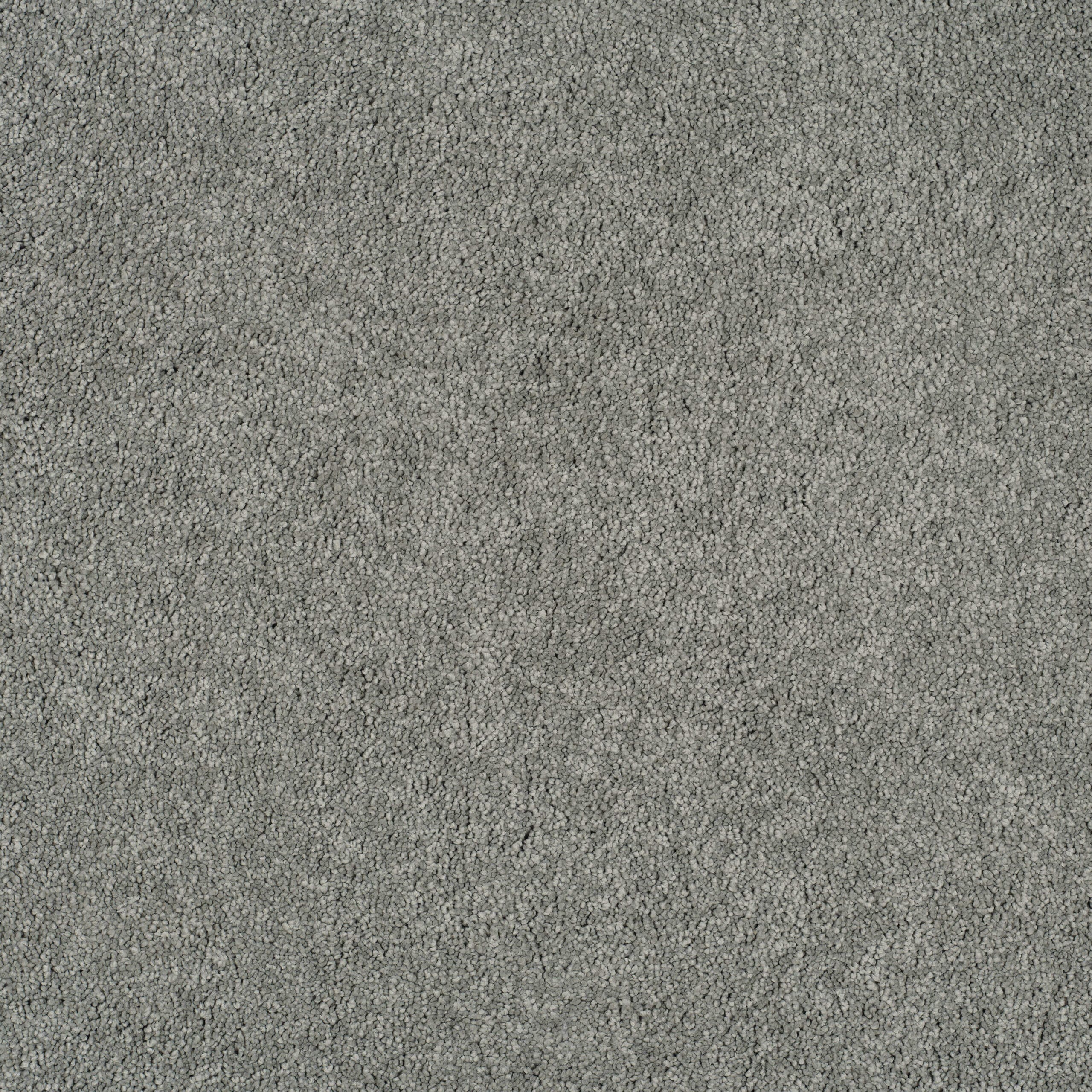 Close-up of gray carpet fibers with a plush loop texture, viewed from above.