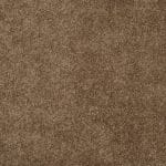 Close-up view of a brown carpet with dense pile fibers, showing a soft textured surface.